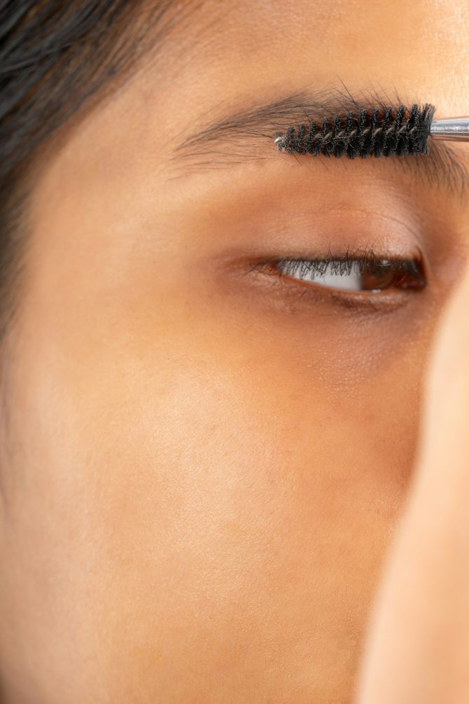 Combing the eyebrows of a young woman